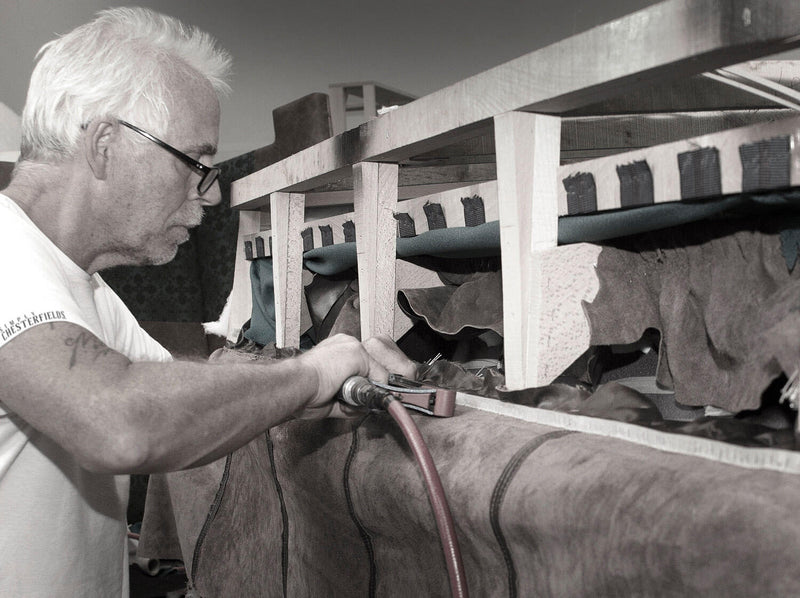 Hand making a leather chesterfield sofa